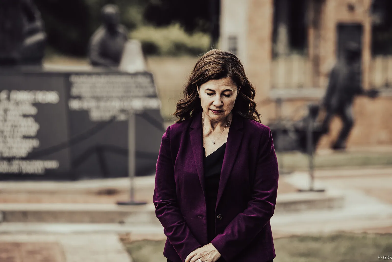 Kristen McDonald Rivet in a reflective moment at a memorial