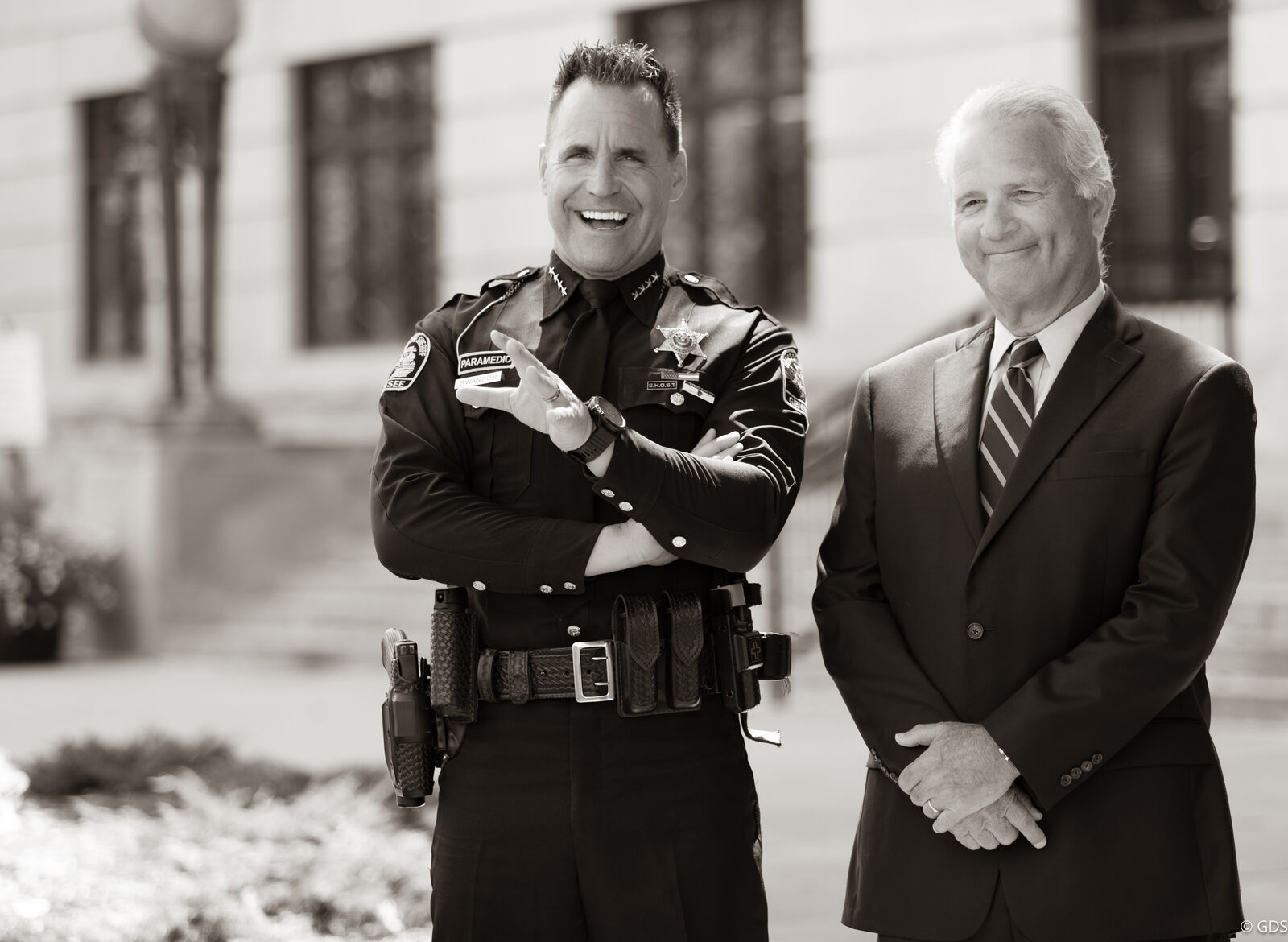 Sheriff Chris Swanson and a candidate outside the county courthouse during a campaign ad shoot