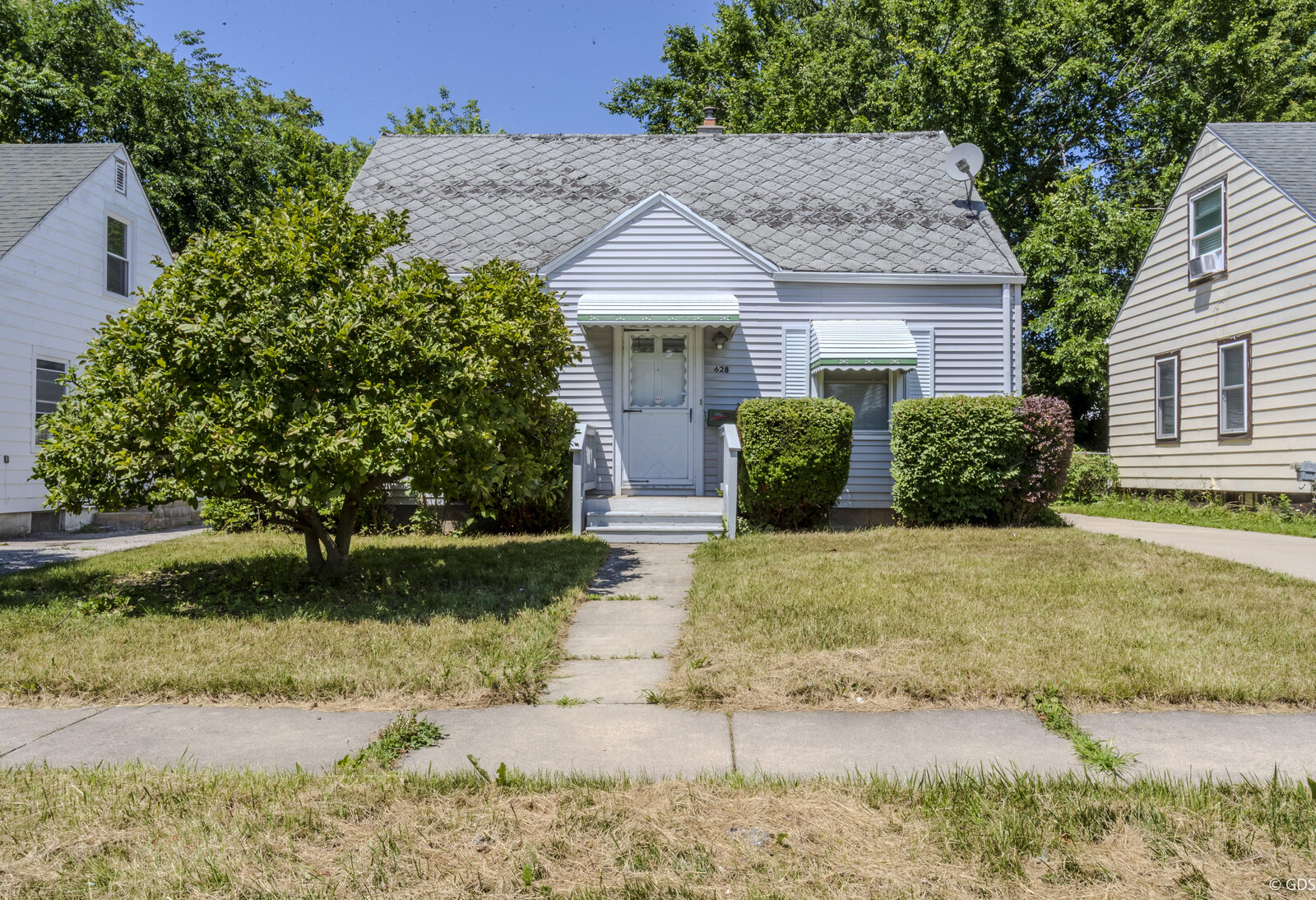 Front exterior of a light-gray Cape Cod home