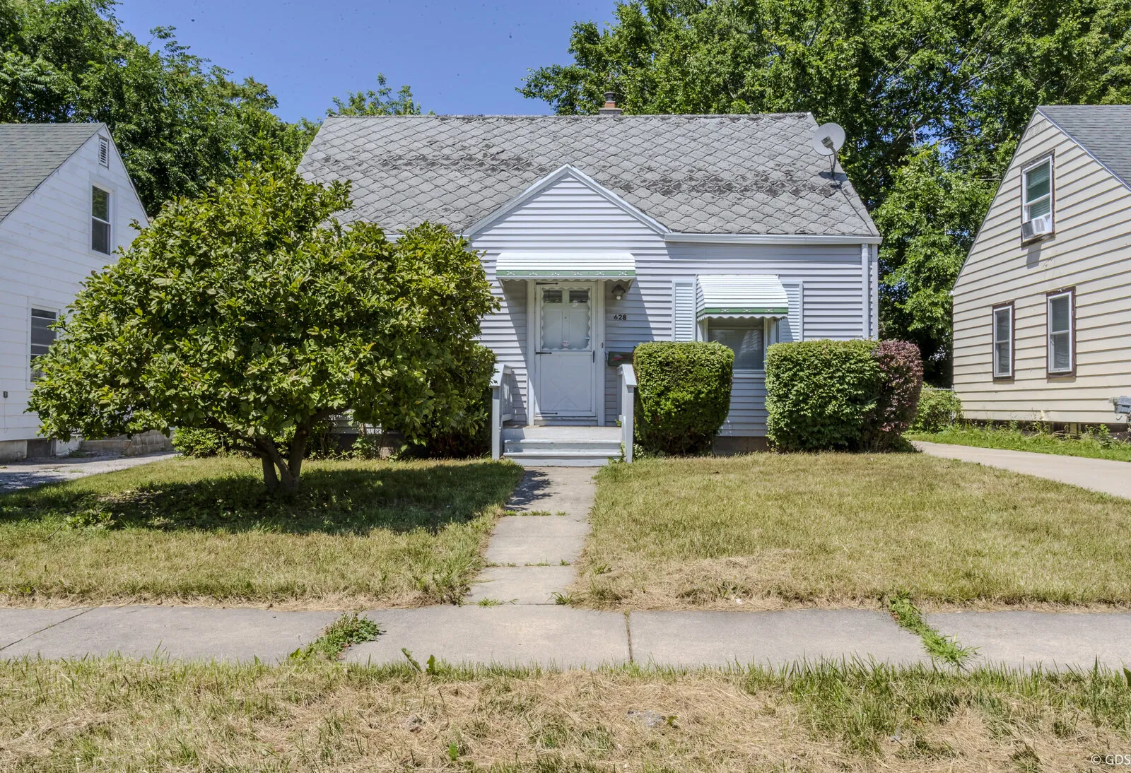 Front exterior of a light-gray Cape Cod home