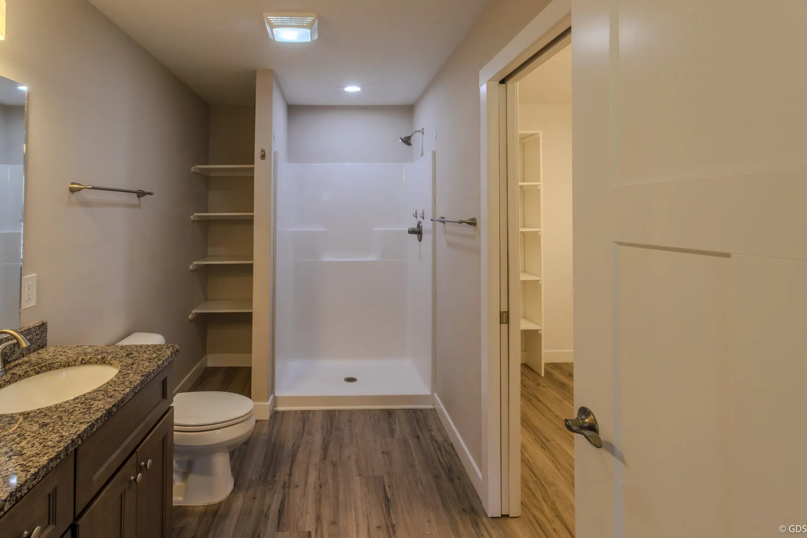 Interior listing photo — updated bathroom with a walk-in shower and granite-top vanity, 419 South Dayton