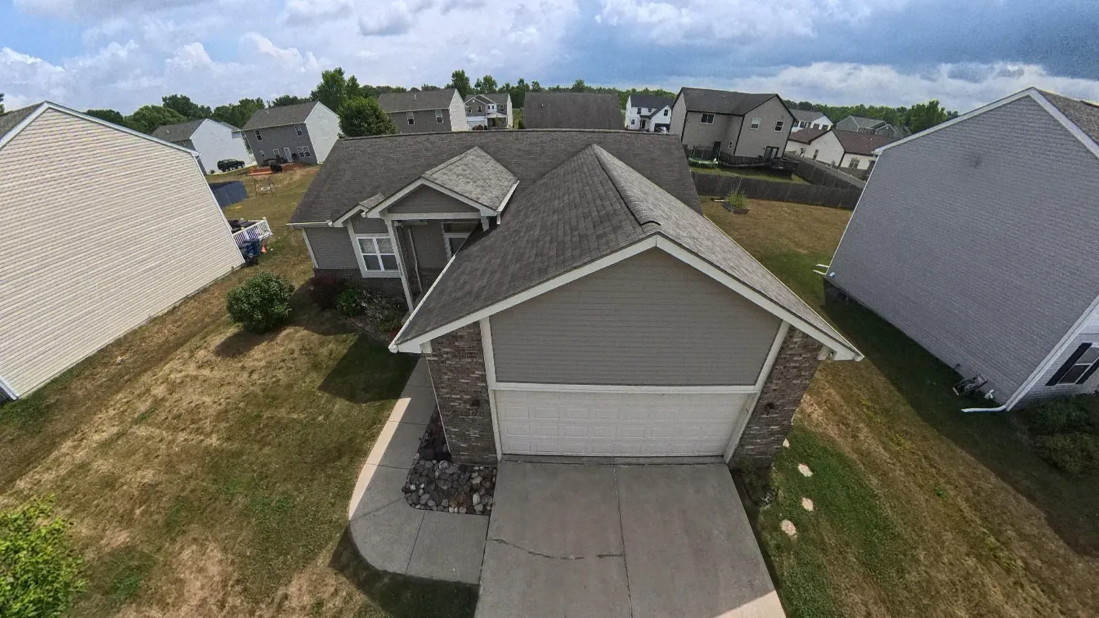 Aerial drone view over the rooftop and two-car garage of 2229 Hunter Lane, Burton