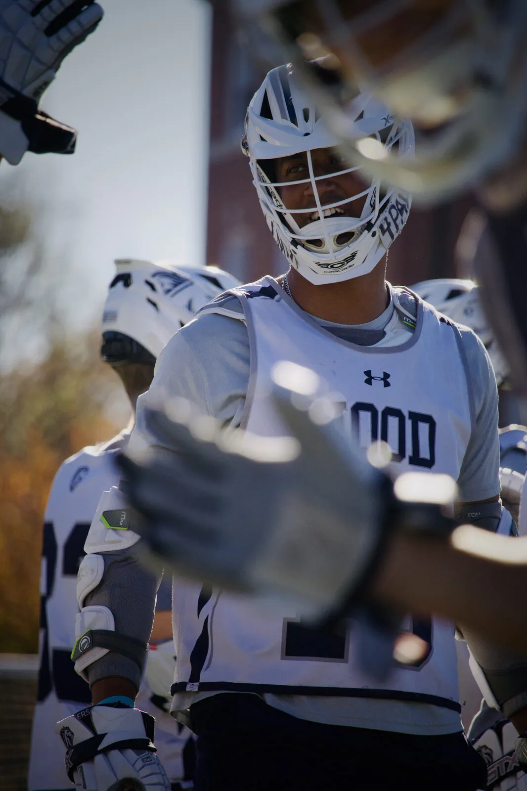 Hood College lacrosse players gathered in white uniforms before the game