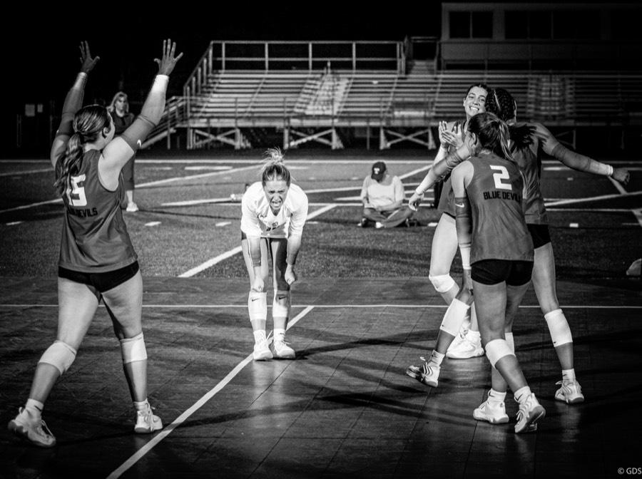 Volleyball player mid-celebration after the winning point